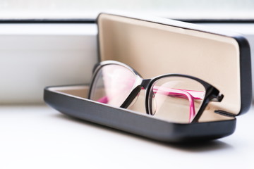 Glasses, white background, leather case