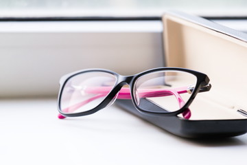 Glasses, white background, leather case