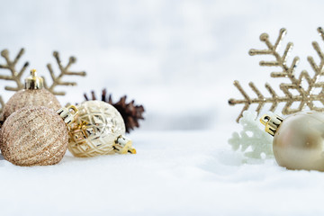 Fototapeta na wymiar Christmas of winter - Christmas balls with ribbon on snow, Winter holidays concept. Christmas red balls, golden balls, pine And Snowflakes decorations In Snow Background