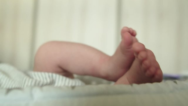 Newborn child moving his tiny legs.