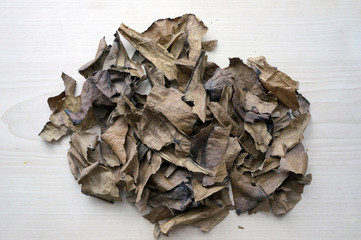 Dried medicinal leaves on a wooden table