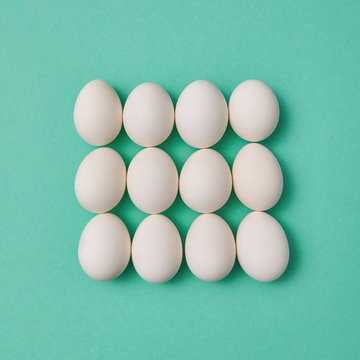 Organic whtite egg pattern on a turquoise background. Easter concept.