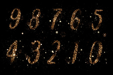 Set of Numbers written in magic sparks of firework. Composition on a black background.