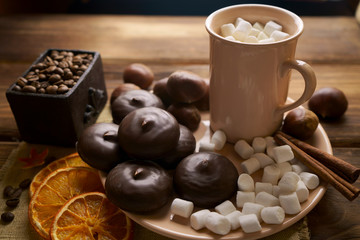 Cup of coffee with marshmallows and marshmallows in chocolate icing