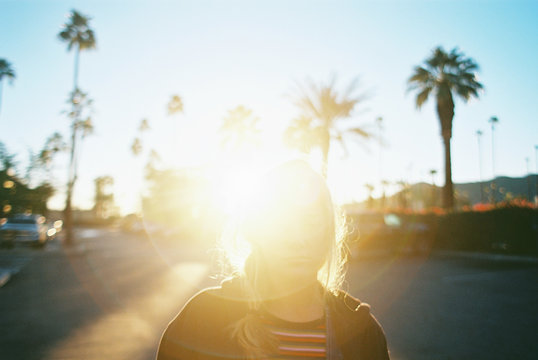 Teen girl with rainbow stripes in bright colors on film