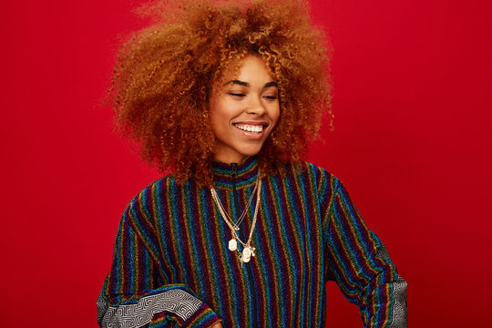 Young stylish woman laughing over red