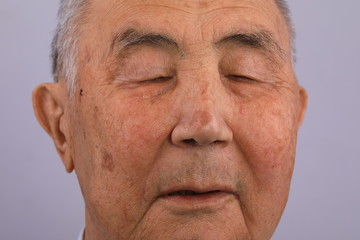 close-up portrait of an old man crying