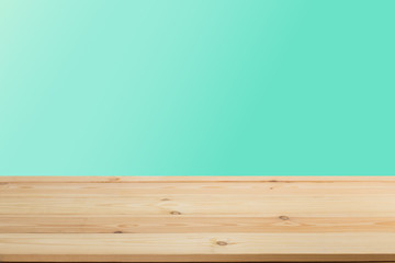 Wooden board empty table in front of a blurred background. Perspective brown wood with blurry grunge or old wall backdrop - can be used to showcase or mount your products.