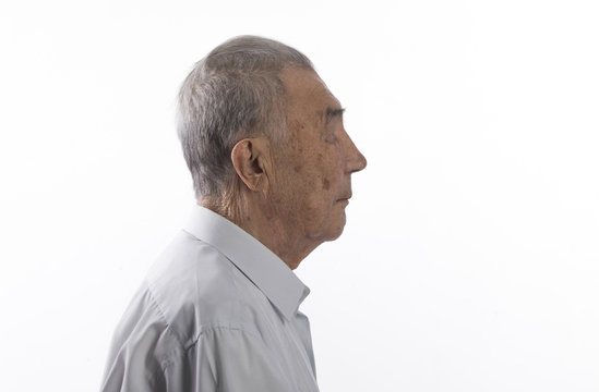 profile portrait of an old man on a white isolated background
