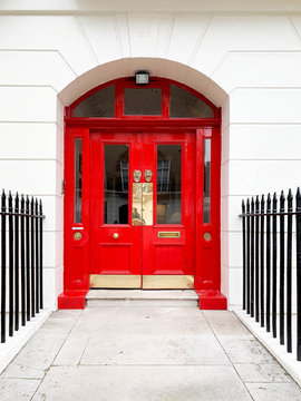 A smart red door and railings.