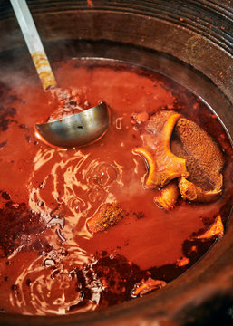 Large pot of red hot tripe soup in Mexico City