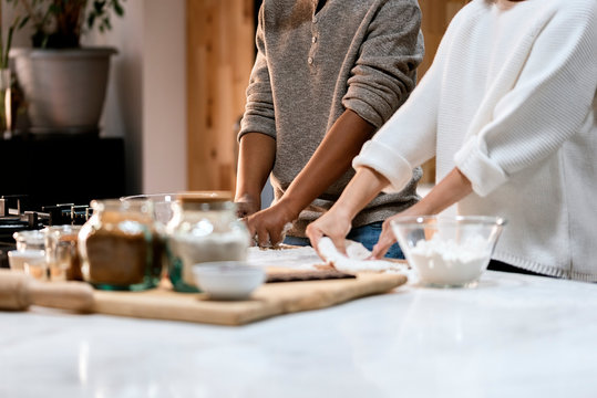 Unrecognizable children making cookies at home