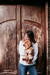 young woman and her cute puppy of cocker spaniel outdoors