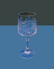 Wine glass with blue and green background.