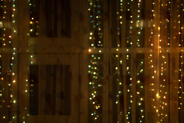 Fototapeta na wymiar Festive christmas decorated window with bulb lights