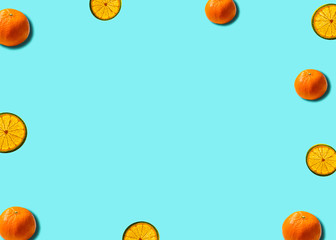 Naklejka na ściany i meble Flat lay citrus concept with mandarin and lemon slice on a soft blue background