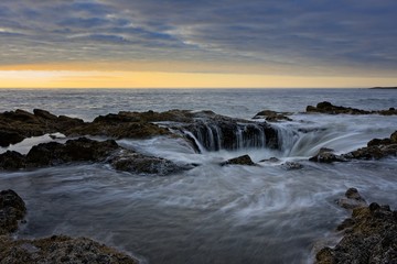 Water flowing into Thor's Well during dramatic sunset Cape Perpetua Oregon Coast