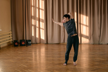 Expressive ethnic man dancing in studio