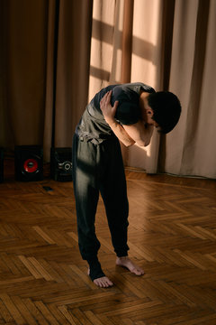 Young barefoot dancer in sunny studio