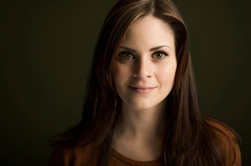 Portrait of young woman on green background