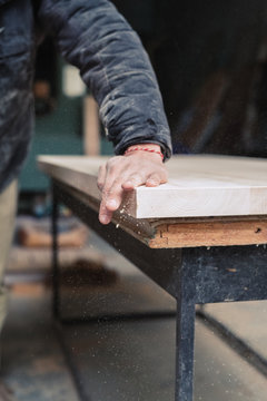 Carpenter sanding plank