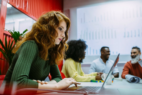 Concentrated businesswoman working in creative office - Powered by Adobe
