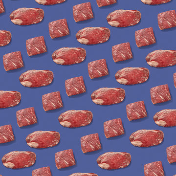 Fresh Raw Beef Meat In A Creative Pattern On A Violet Background