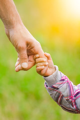 hands Happy parents and child outdoors in the park