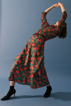 model with floral pattern dress on blue background