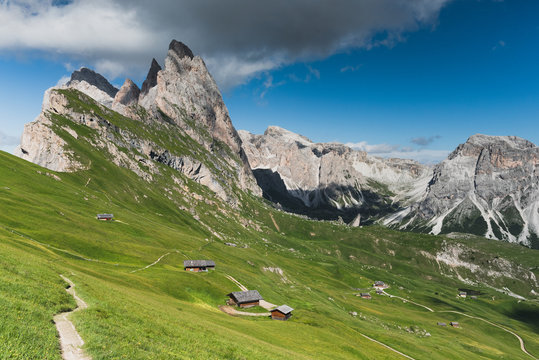Landscape view of mountains and green hills with wooden huts