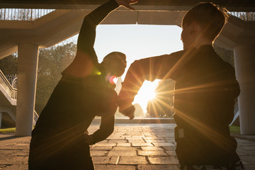 Sportive couple in park working out in sunlight