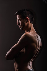 Strong athletic man on black background, Fitness shaped muscle man posing 