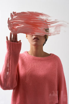 Young woman with face covered behind smear