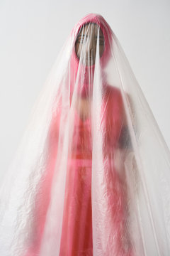 Model with hidden face under plastic