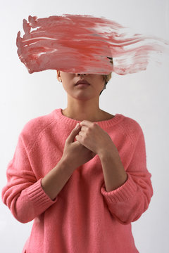 Contemporary model with paint smear covering face