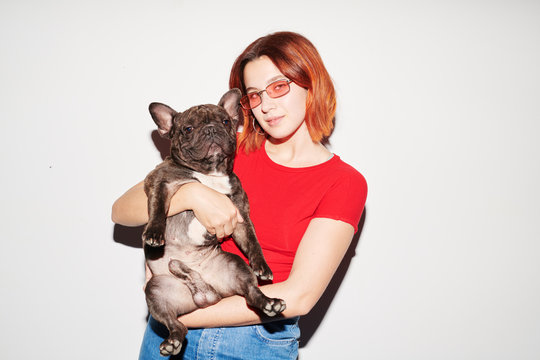 Cool girl holding black bulldog