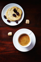 Cup of Coffee with cookies on brown wooden background. Top view. 