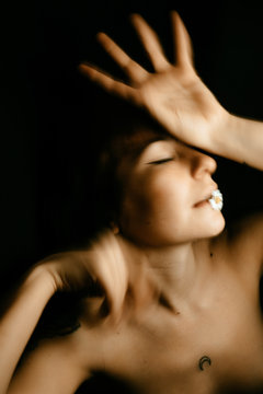 portraits of woman with small daisy in motion