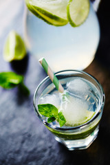 Gin and Tonic on black stone background. Close up.