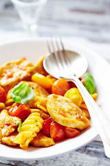 Pasta with cherry tomatoes and chicken breast. Close up. 