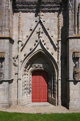 Entrance with gothic tracery and wooden door at Saint Tugen chapel in Primelin village, France