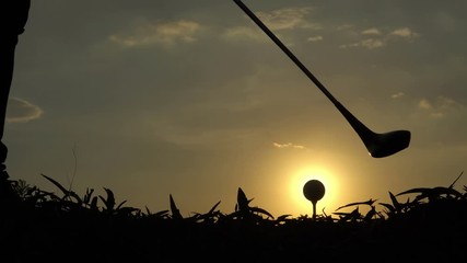 Silhouette of golf player play golf on sunset,Thailand people are practicing golf drive for race day.