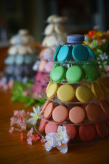 Obraz na płótnie Canvas Towers of rainbow multicolored macaron shells for display.