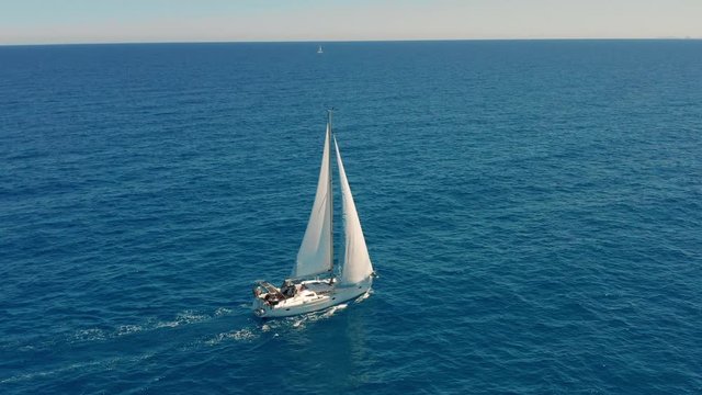 Yacht sailing on opened sea. Sailing boat. Yachting video. Yacht from above. Yachting at windy day. Yacht. Sailboat.