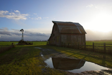 old barn in reflection with windmill