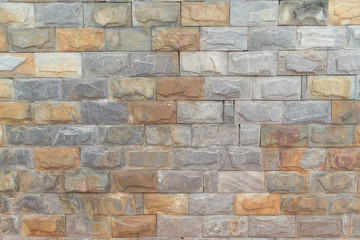 The texture of the wall is made of smooth stone blocks