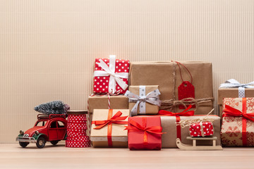 christmas gifts pile and toy car with fir-tree