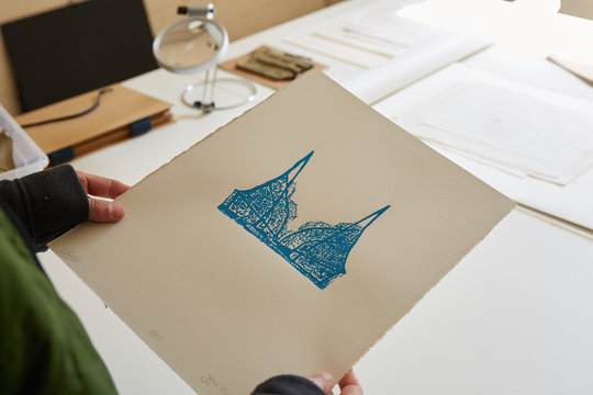 Artist holding paper with art work