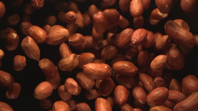 Peanuts Nuts Flying in the Air in a Free Fall in Slow Motion on Black Background at 1500 fps