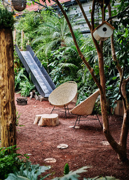 Modern seats in garden with playground